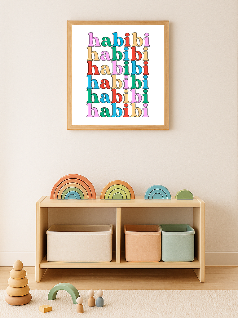Framed artwork with 'habibi' text in colorful letters above a shelf with storage bins and toys.