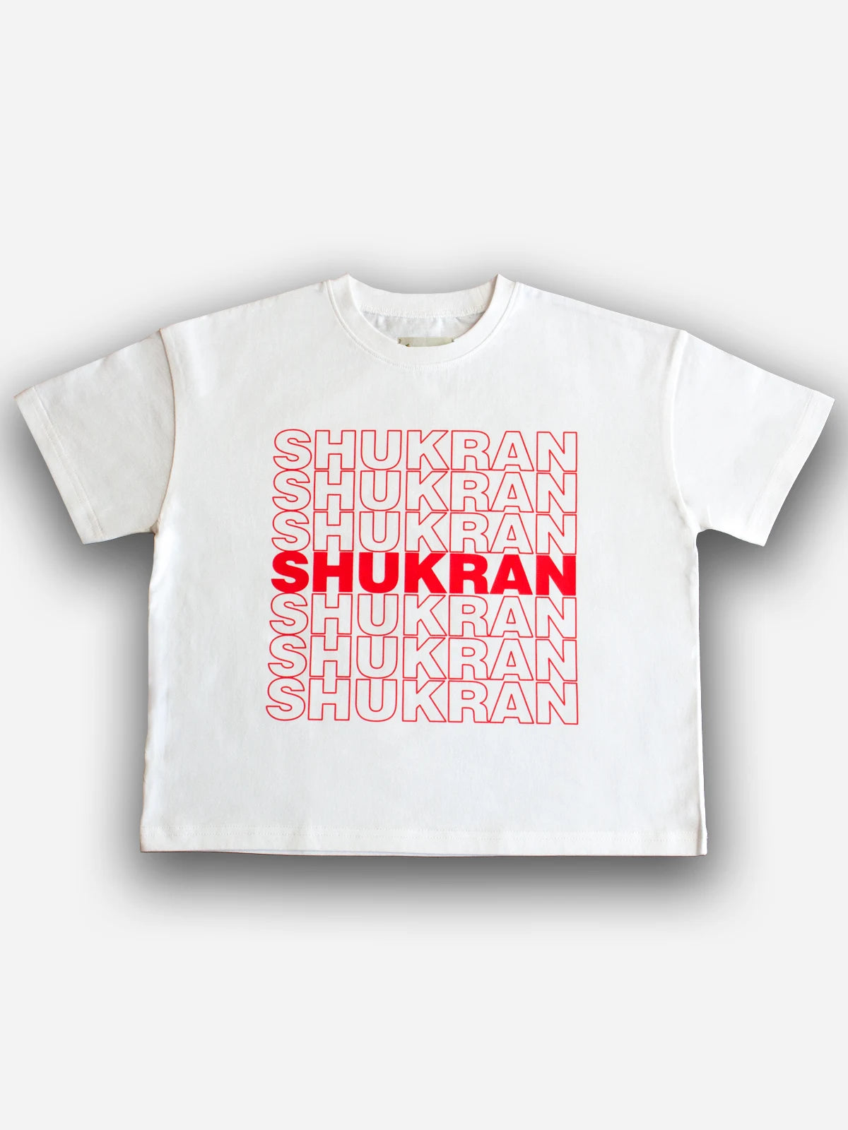 White Shukran kids tee with red lettering