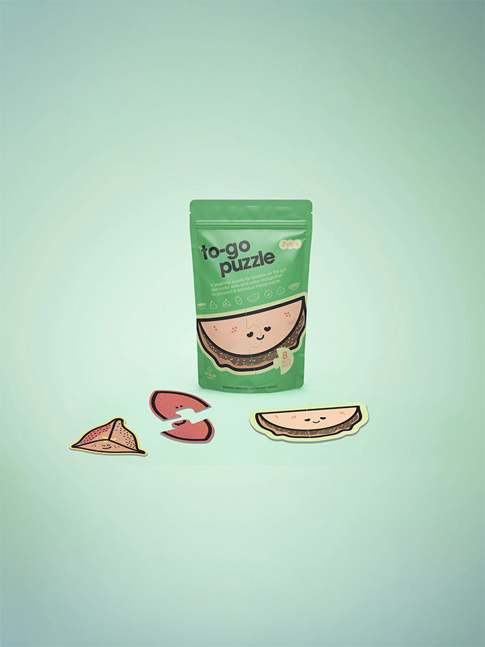 Green packaging of 'to-go puzzle' with cute watermelon design on a light green background