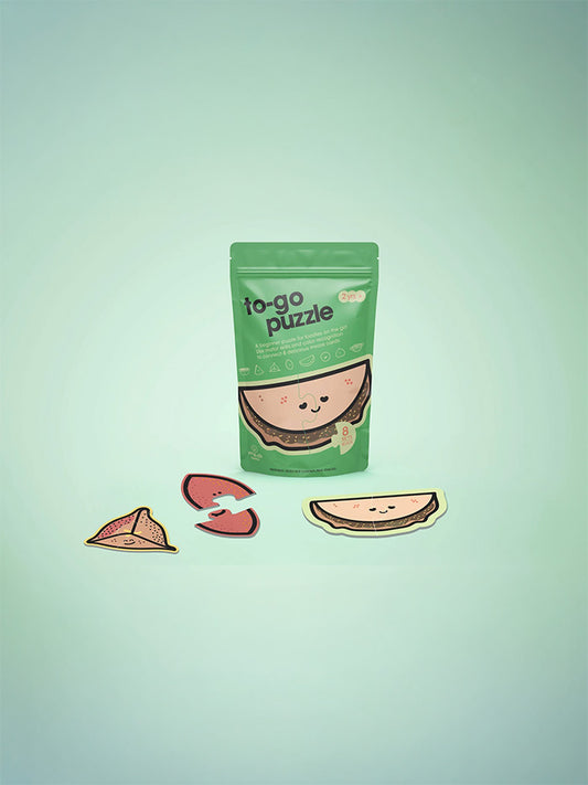 Green packaging of 'to-go puzzle' with cute watermelon design on a light green background